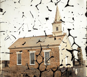 "A weathered historical photograph of Spring Prairie Lutheran Church in Dane County, Wisconsin, circa 1870s. The simple white clapboard structure features tall windows and a prominent steeple. The image is cracked and faded with age, mirroring the passage of time but preserving the legacy of early Norwegian settlers."
